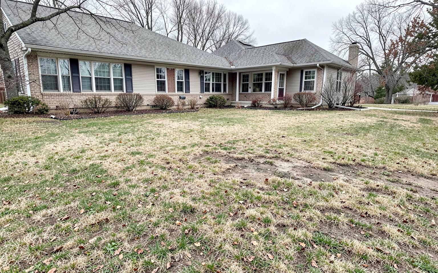 Bare uneven backyard before patio site preparation