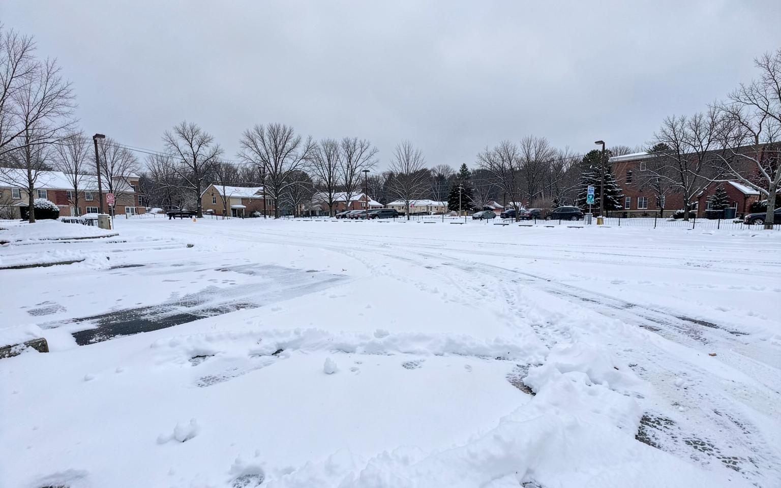 Commercial parking lot and walkways covered after a snowstorm